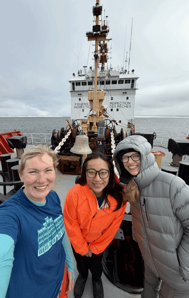 From left, polar scientist Karen Frey and geography Ph.D. students Anna Zhu and Morgan Lehman of Clark’s School of Climate, Environment, and Society aboard the Canadian Coast Guard Cutter Sir Wilfrid Laurier in the Pacific Arctic, July 2026. (Photo courtesy of Karen Frey)