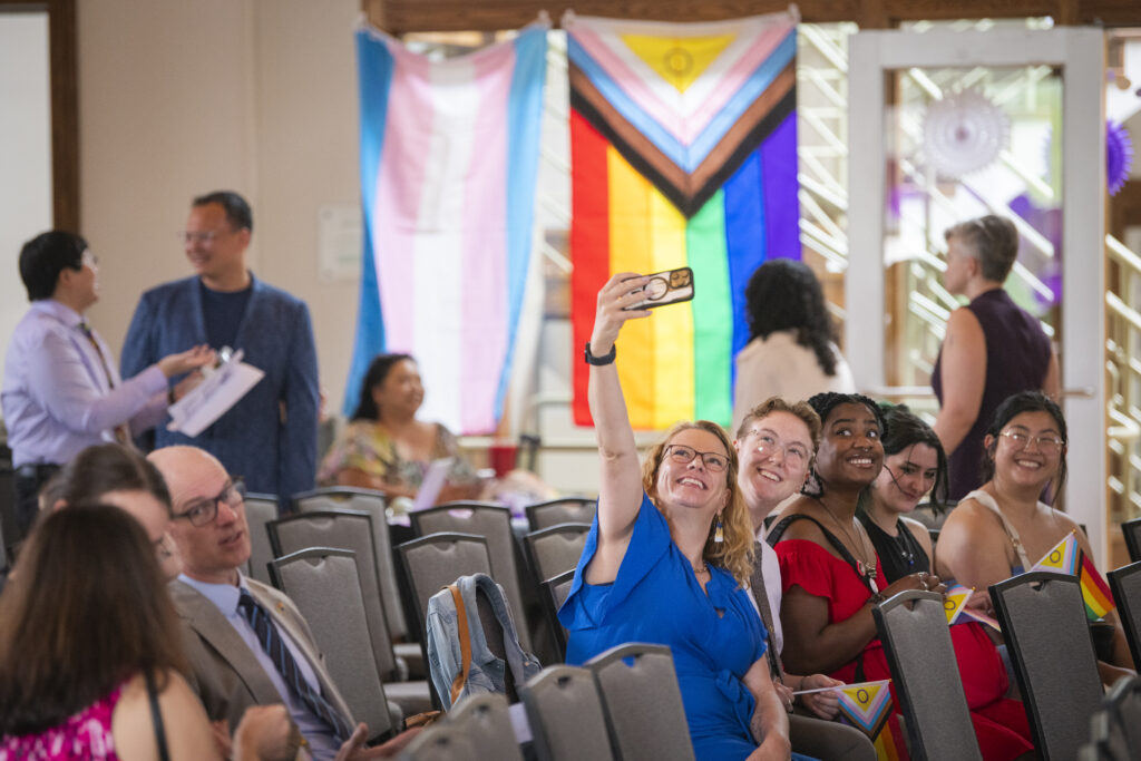 people pose for photos at lavender graduation ceremony