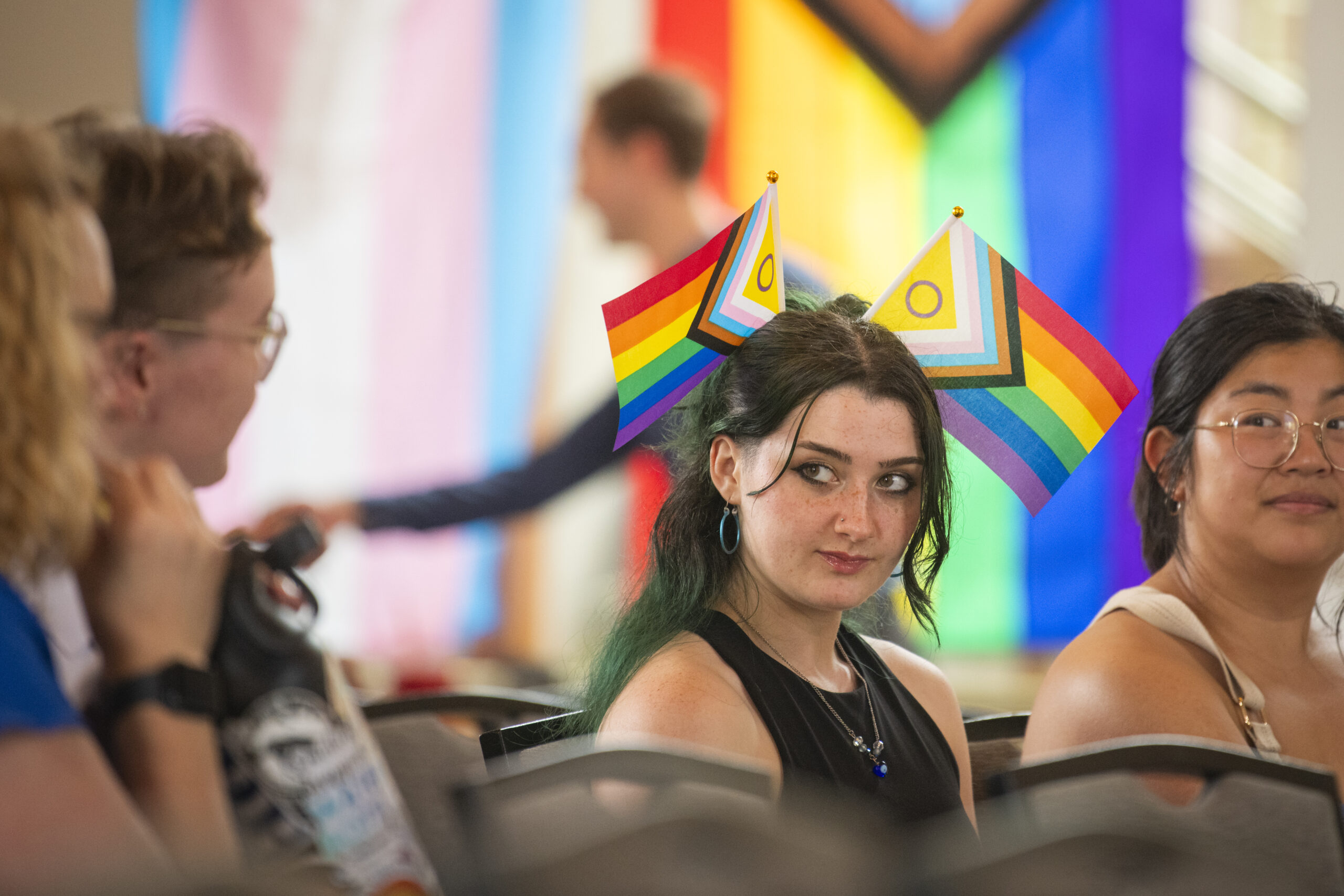 people pose for photos at lavender graduation ceremony