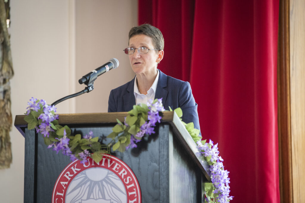 people pose for photos at lavender graduation ceremony