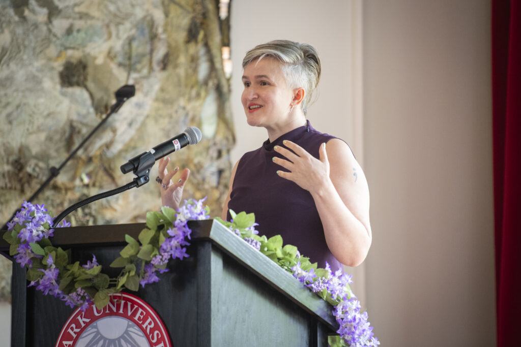 people pose for photos at lavender graduation ceremony