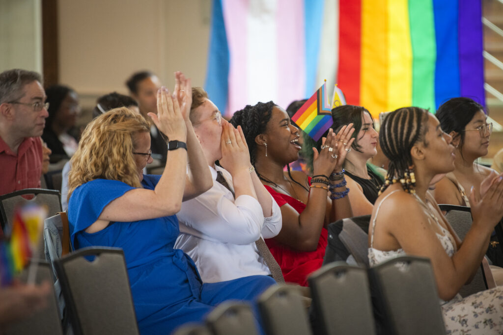 people pose for photos at lavender graduation ceremony
