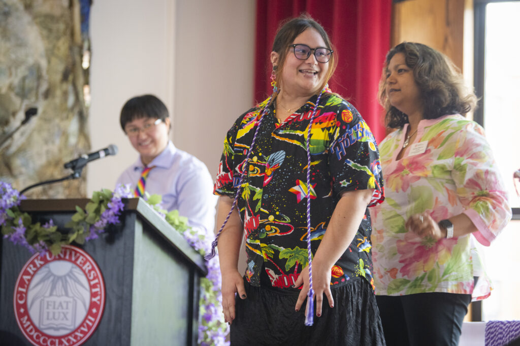 people pose for photos at lavender graduation ceremony