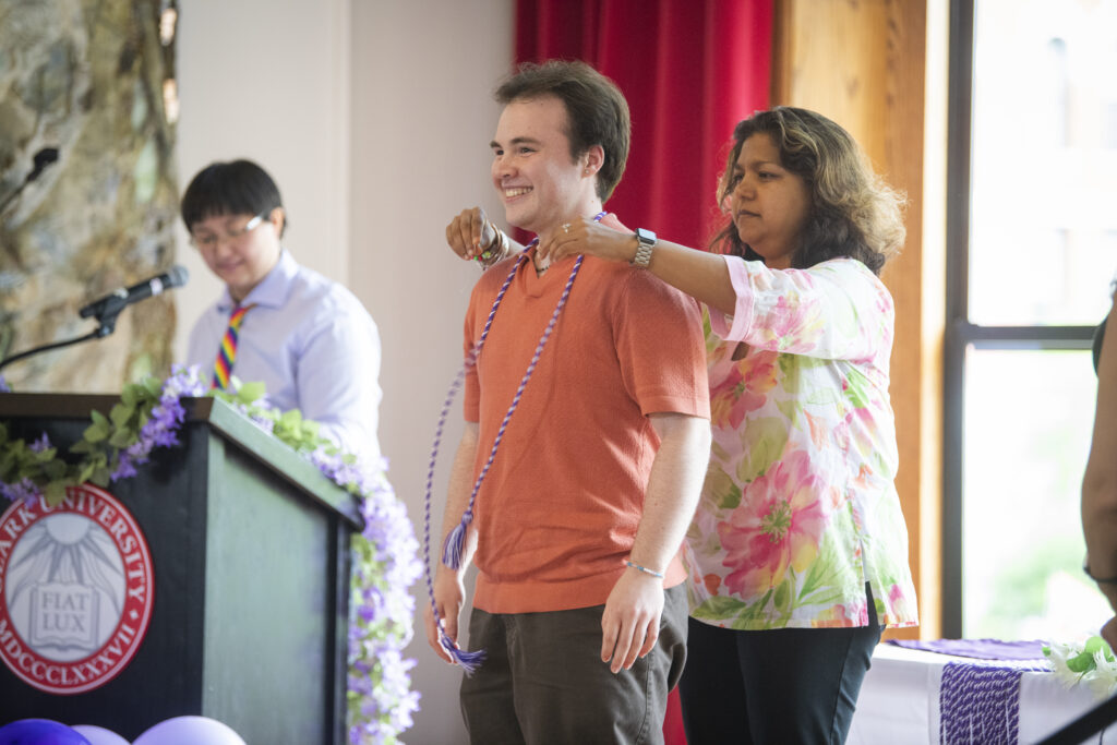 people pose for photos at lavender graduation ceremony