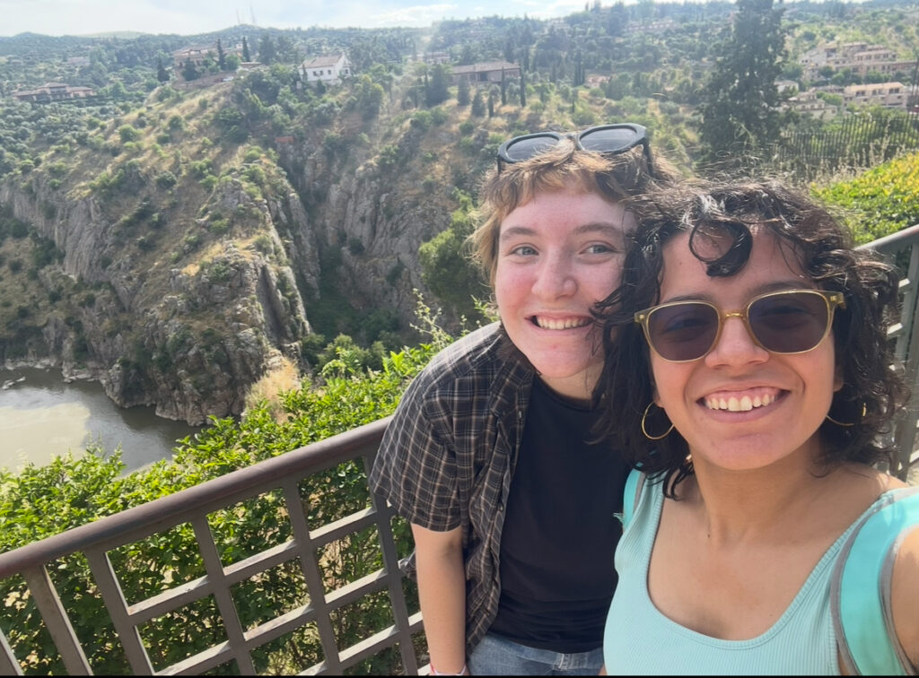two students pose with landscape