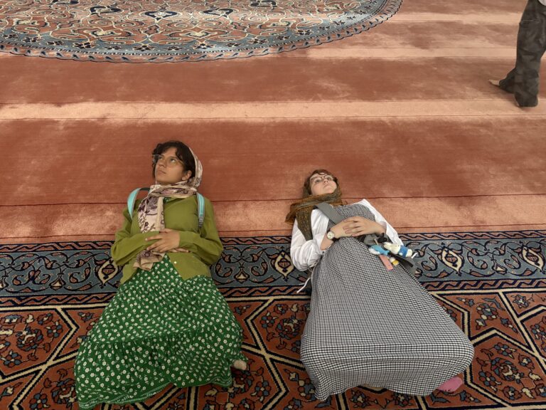 two people laying on orange carpet