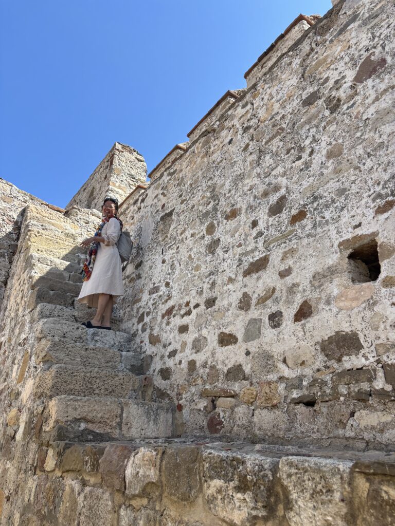 student stands on stairs at castle