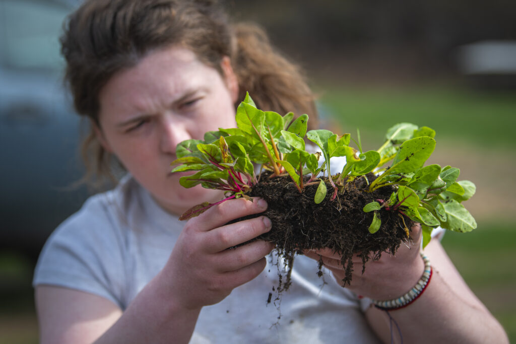 student holding plant