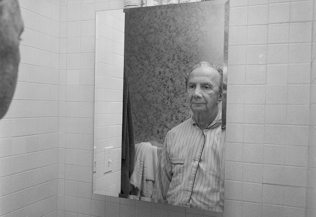 Gene DiRado looks at himself in the mirror