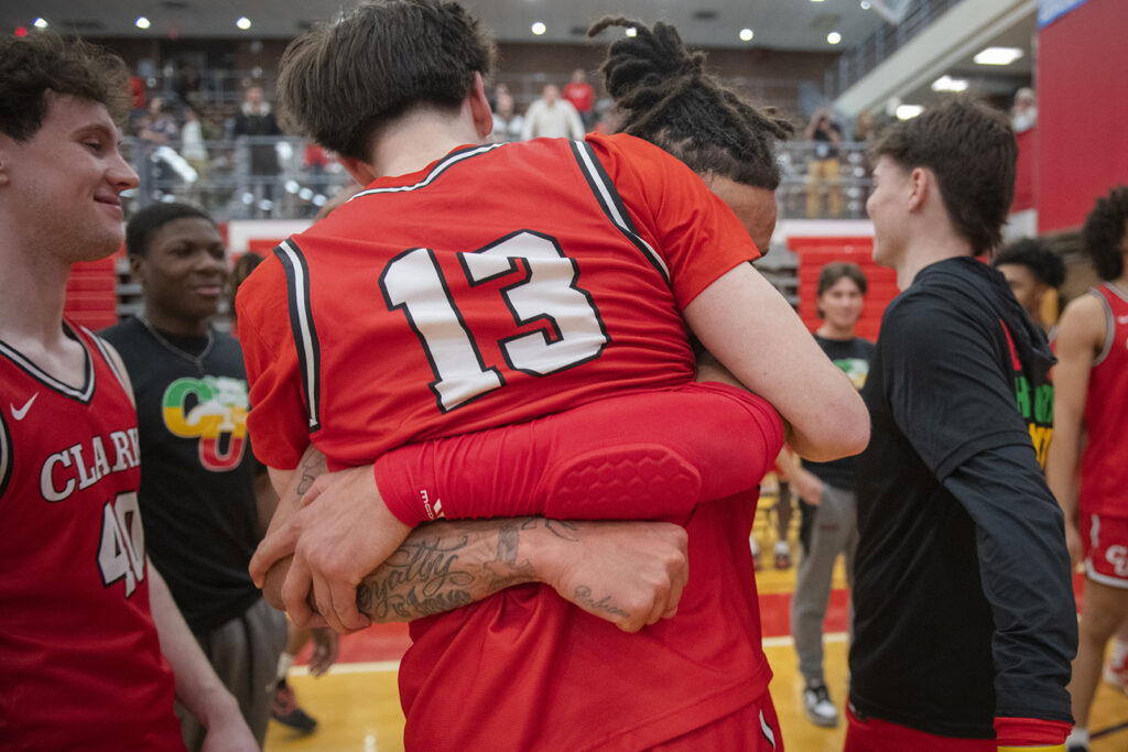 Clark University men's basketball team celebrates win in 2025 NEWMAC championship game