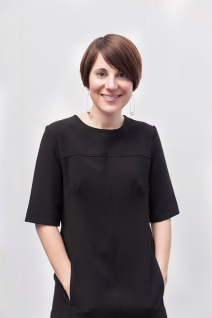 headshot of woman in black dress