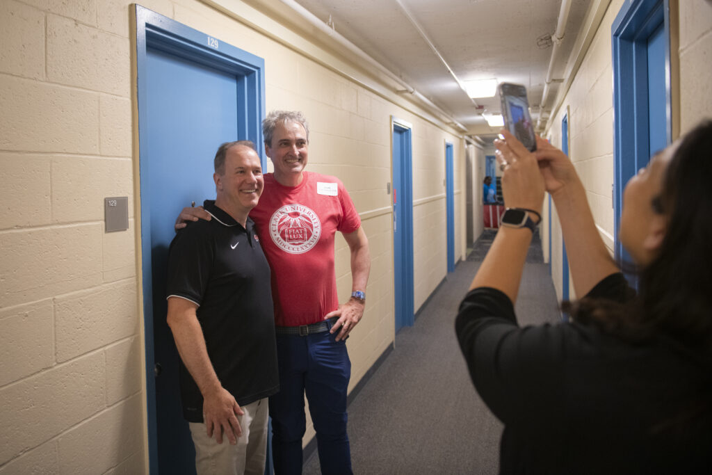university president and parent take photo