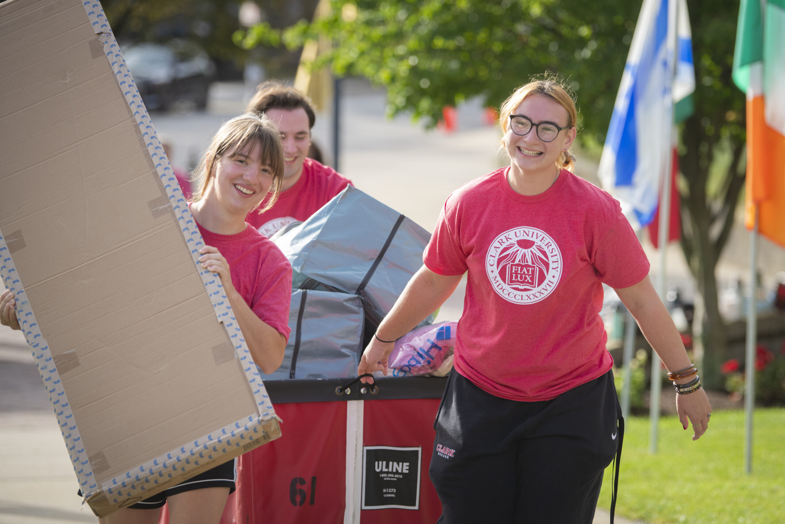 three people carry supplies