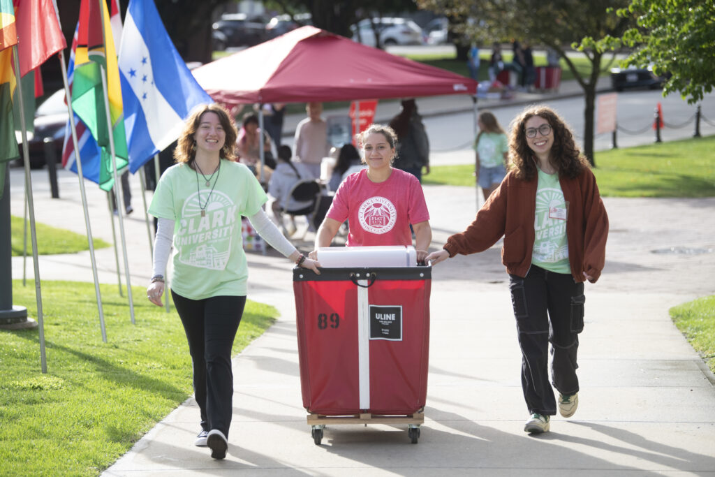 three people move bin
