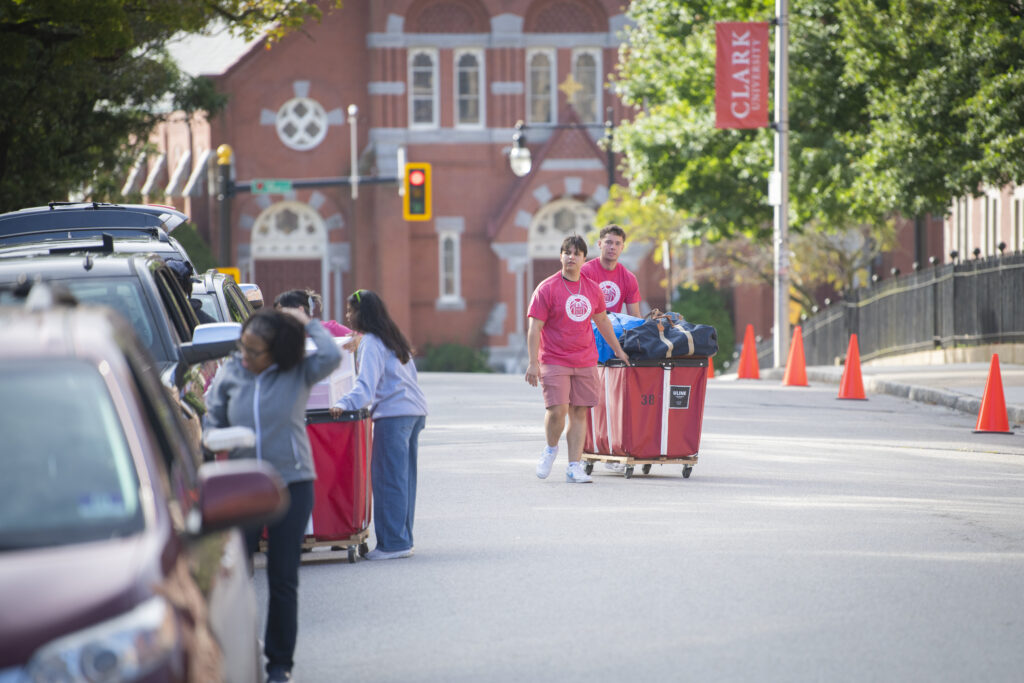 students move bin down street
