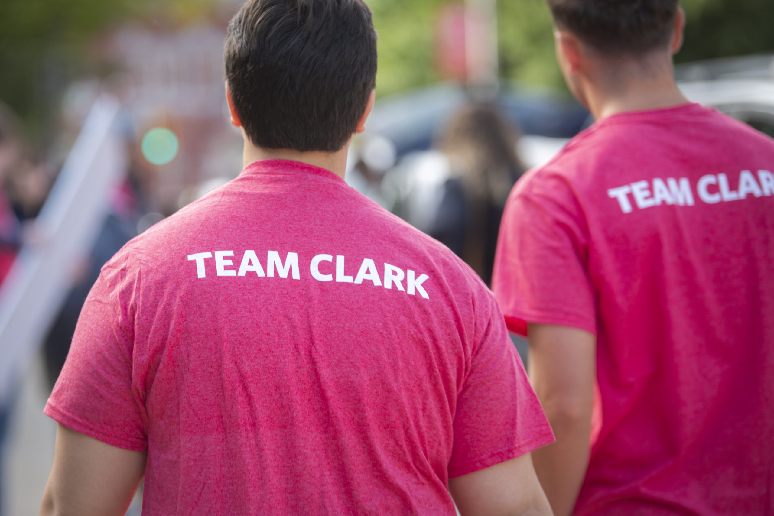 two people wearing shirts that say "team clark"