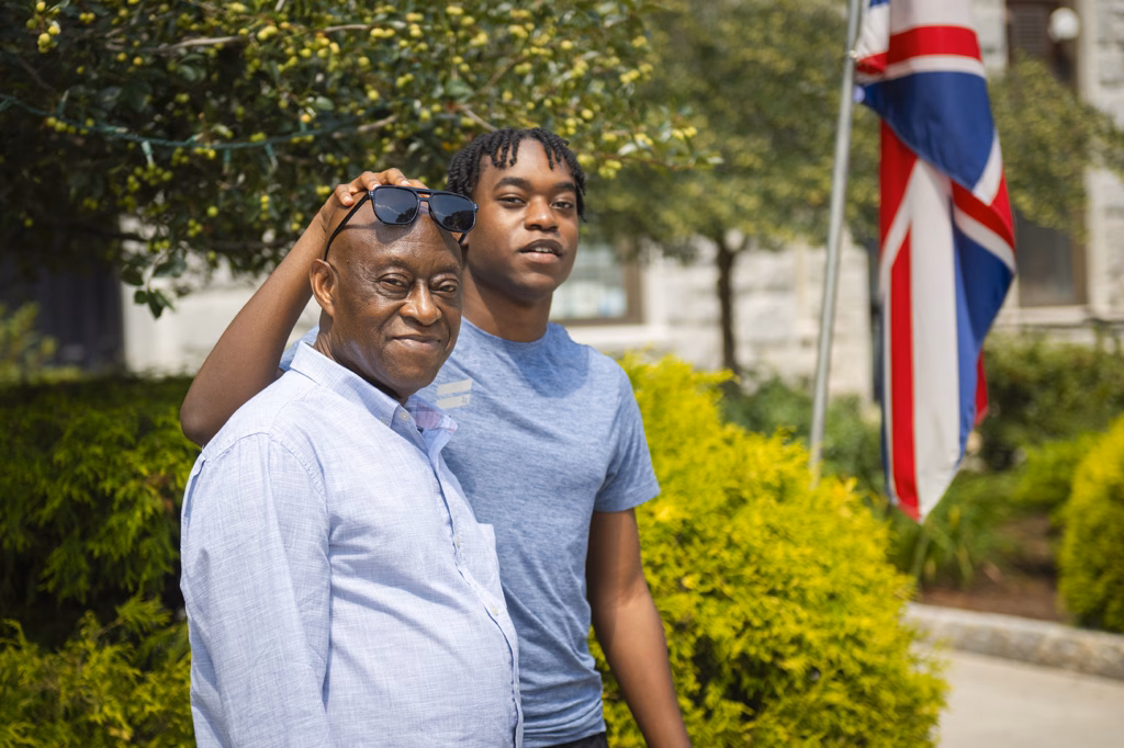 Son puts his hand on his father's head