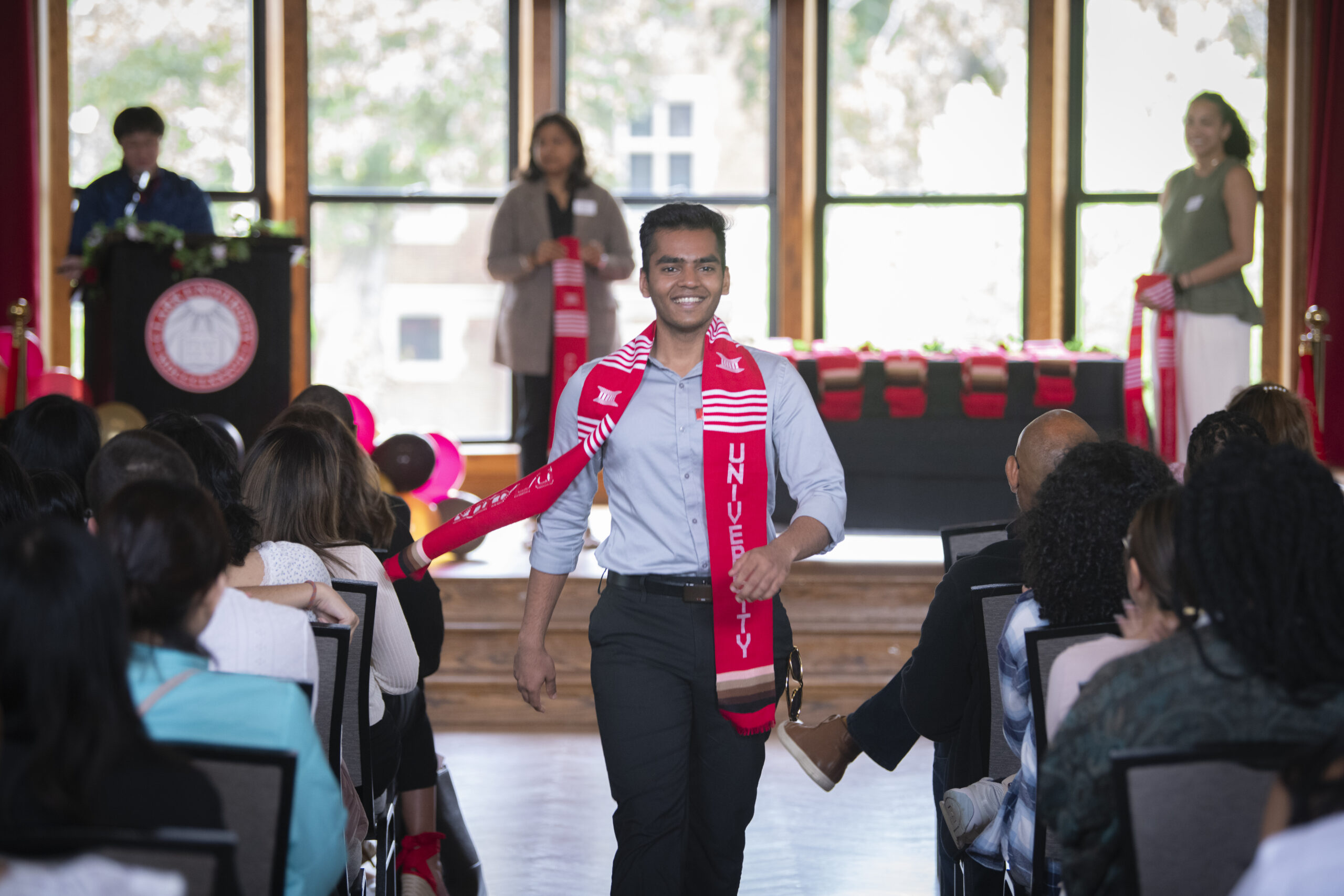 people pose for photos at multicultural graduation ceremony