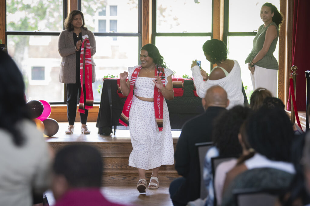 people pose for photos at multicultural graduation ceremony