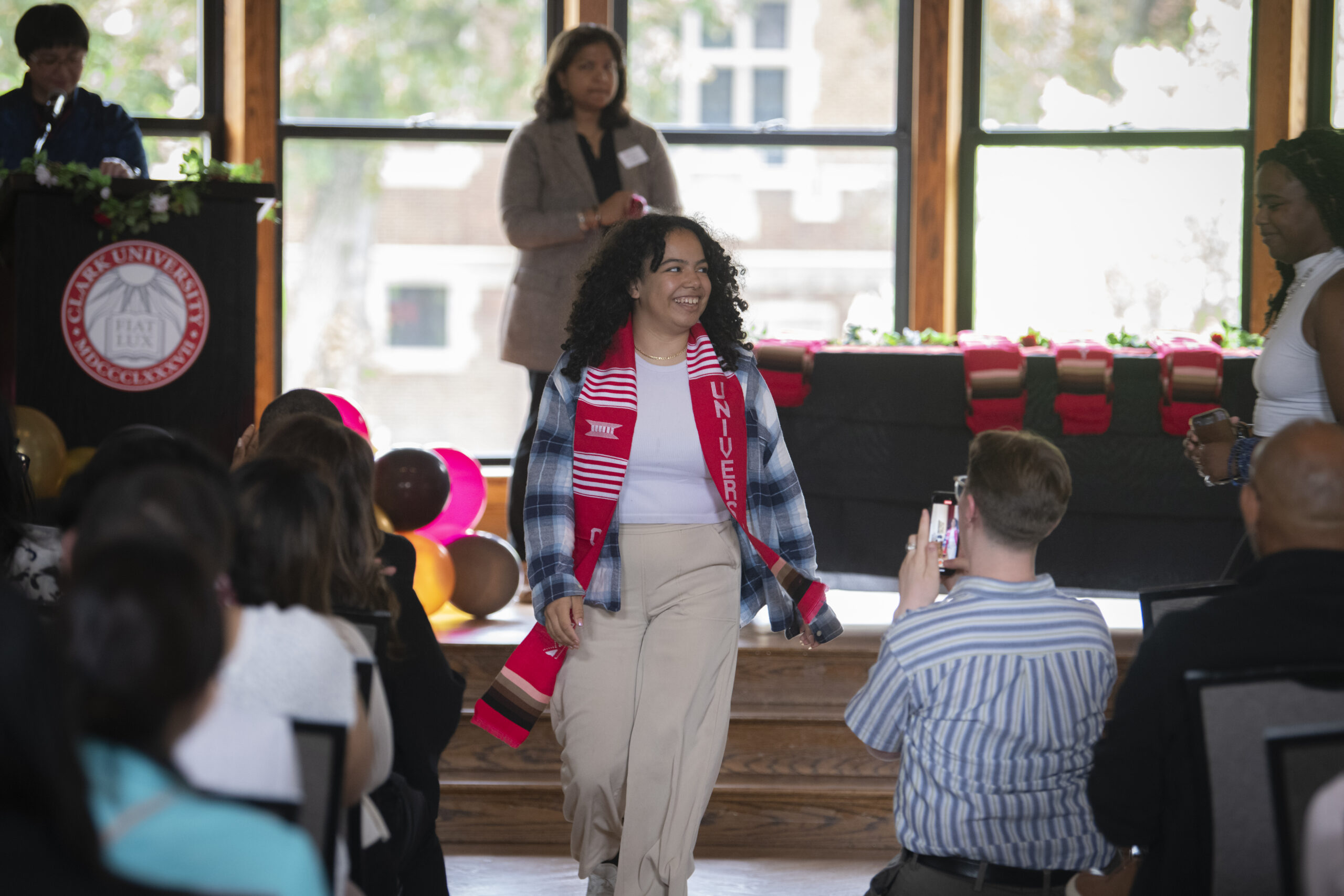 people pose for photos at multicultural graduation ceremony