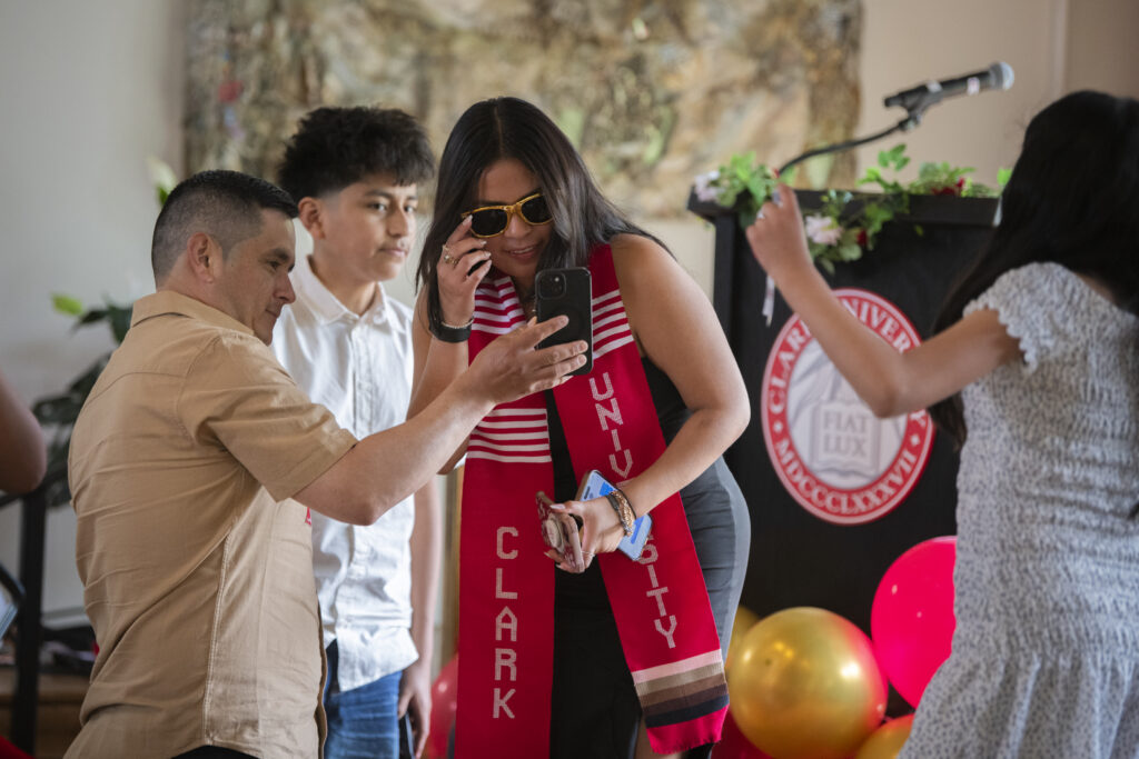 people pose for photos at multicultural graduation ceremony
