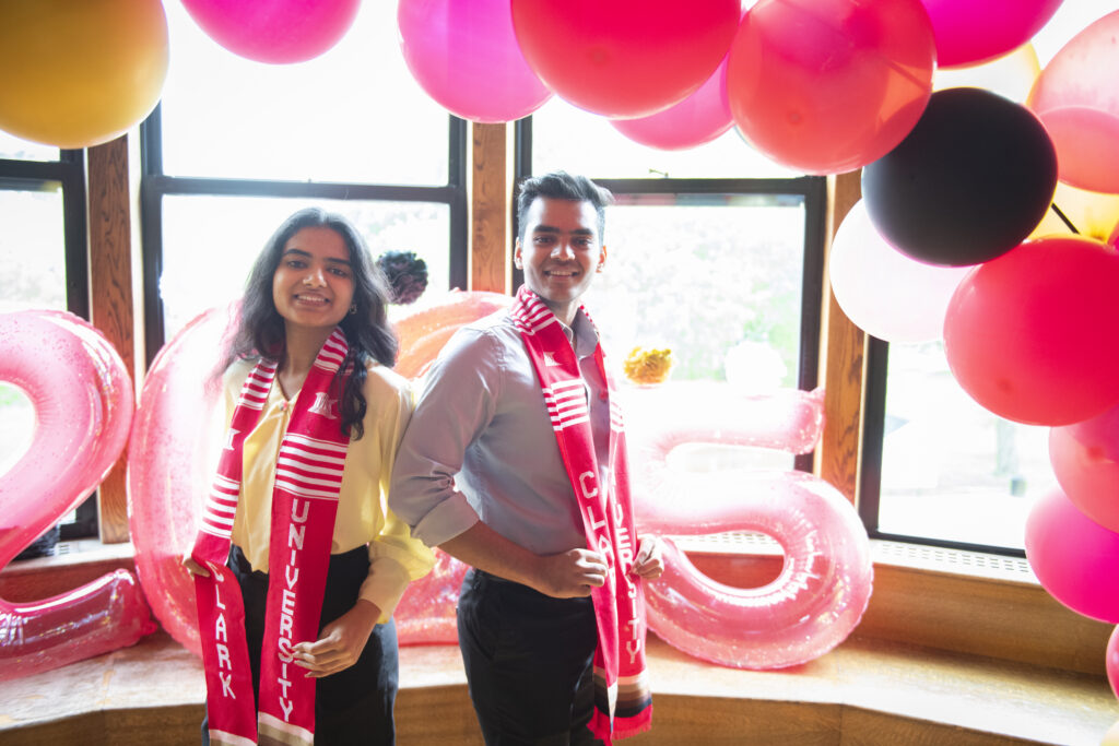 people pose for photos at multicultural graduation ceremony
