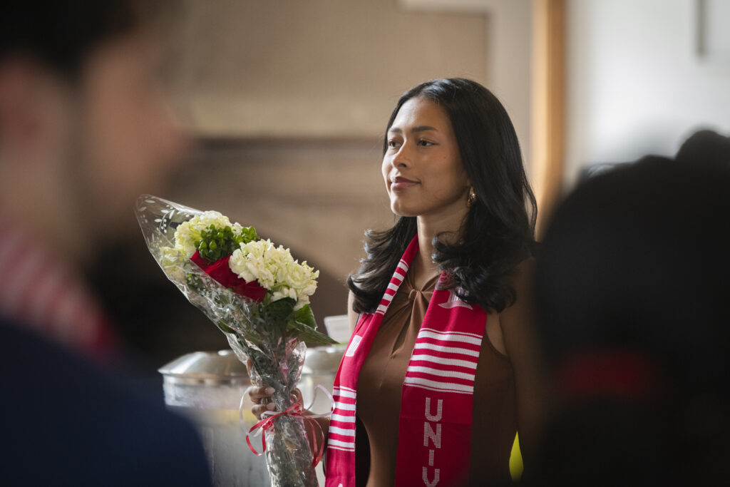 people pose for photos at multicultural graduation ceremony