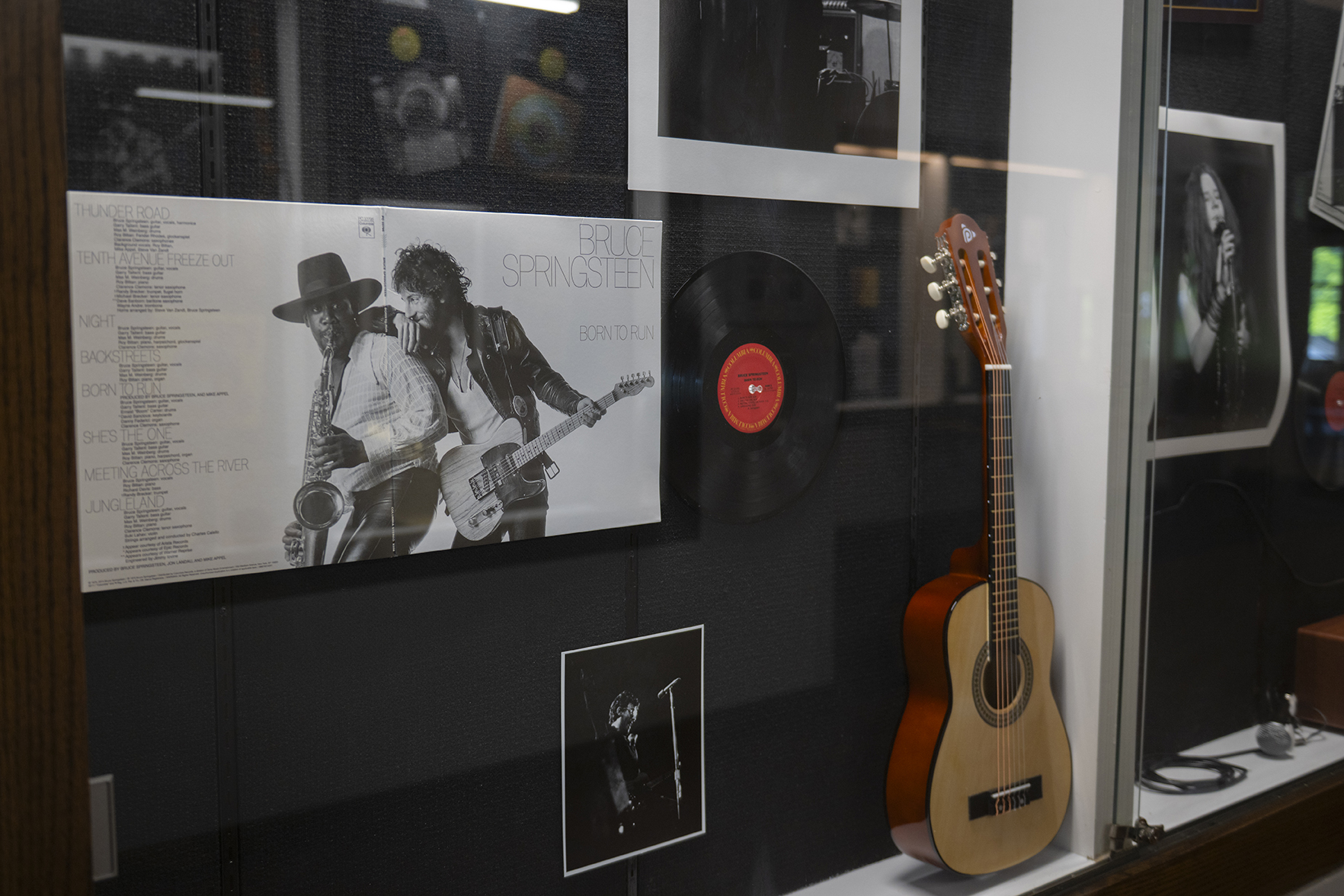 Display with album cover, photos, and guitar, marking Bruce Springteen's 1974 concert at Clark University