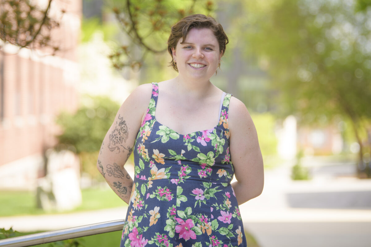 student poses for photo on campus