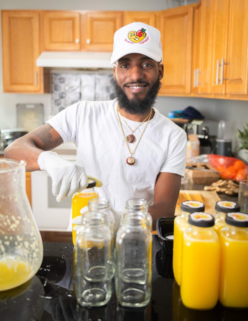 Nate Bethancourt bottling juice for his business, Health Ya'Self