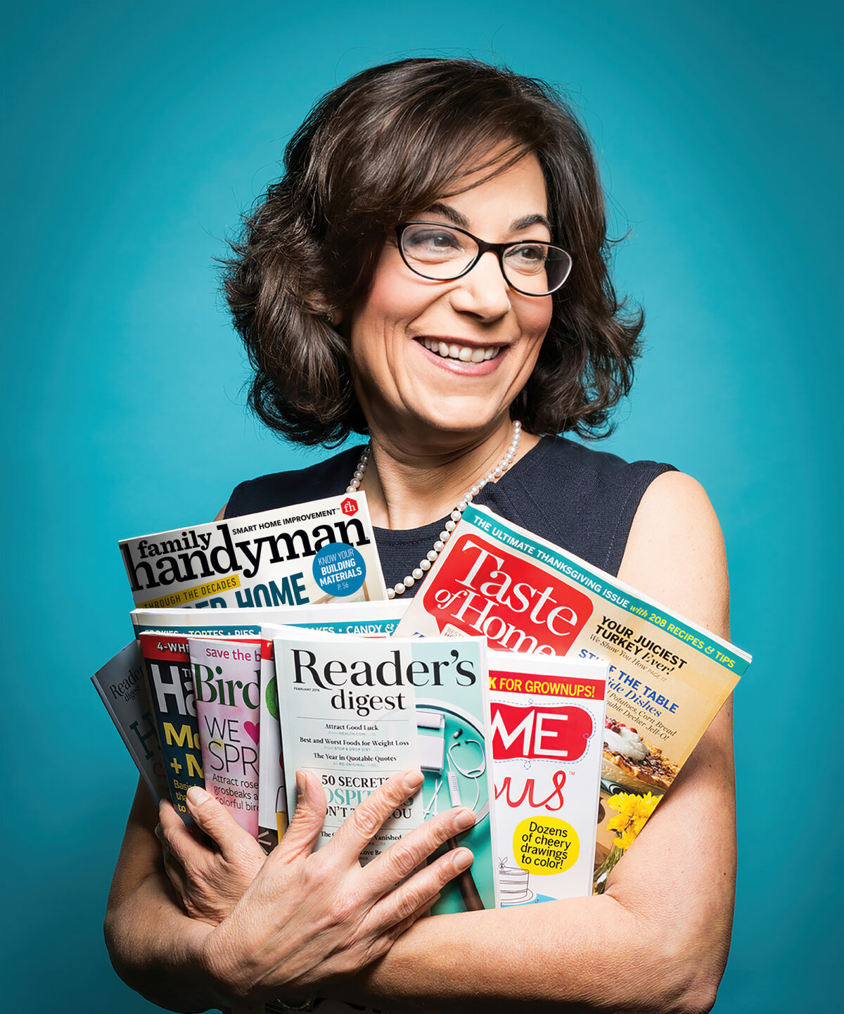Bonnie Kintzer holding magazines published by Trusted Media Brands