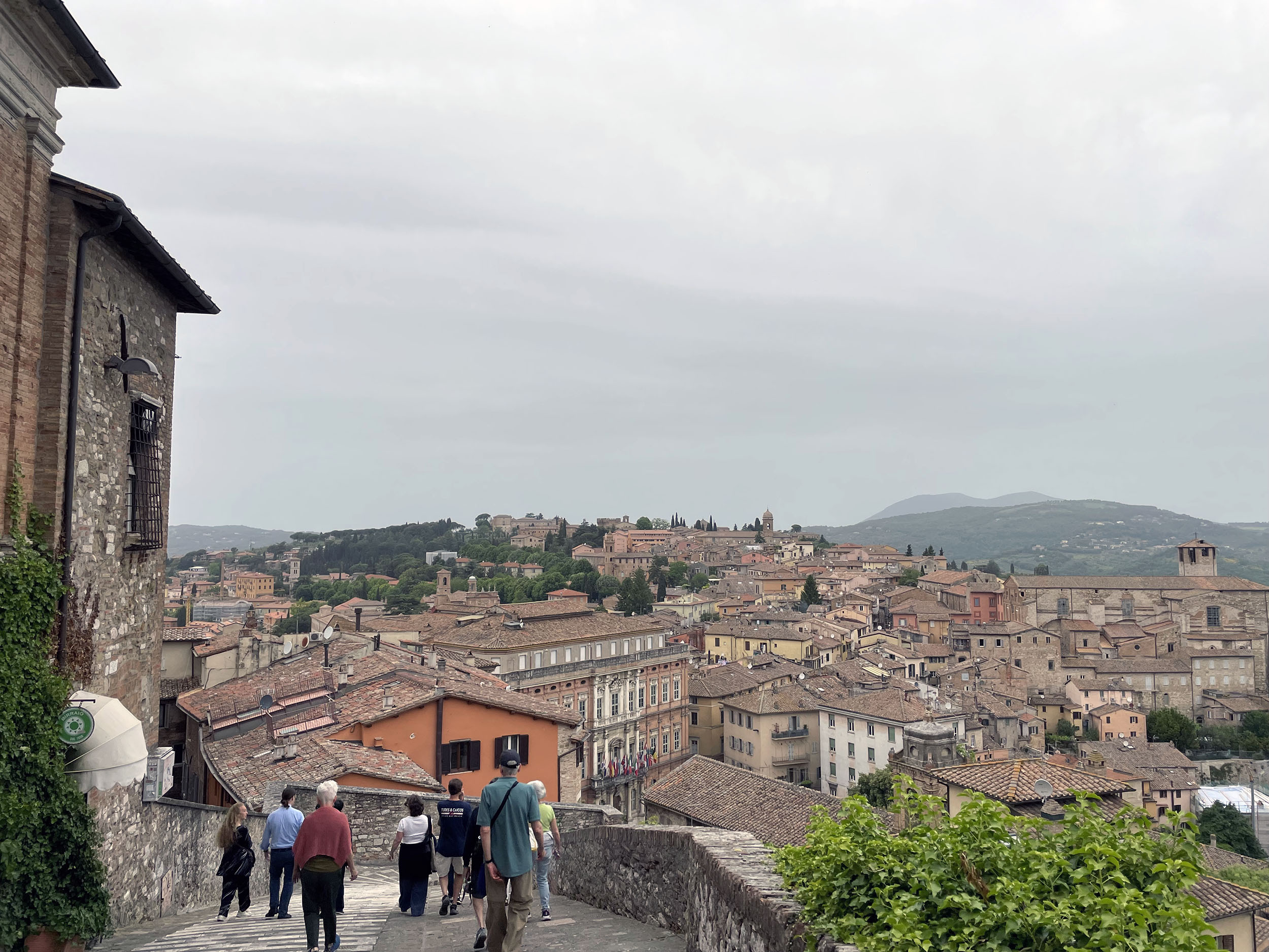 Clark students and faculty walk down hill in Perugia, Italy