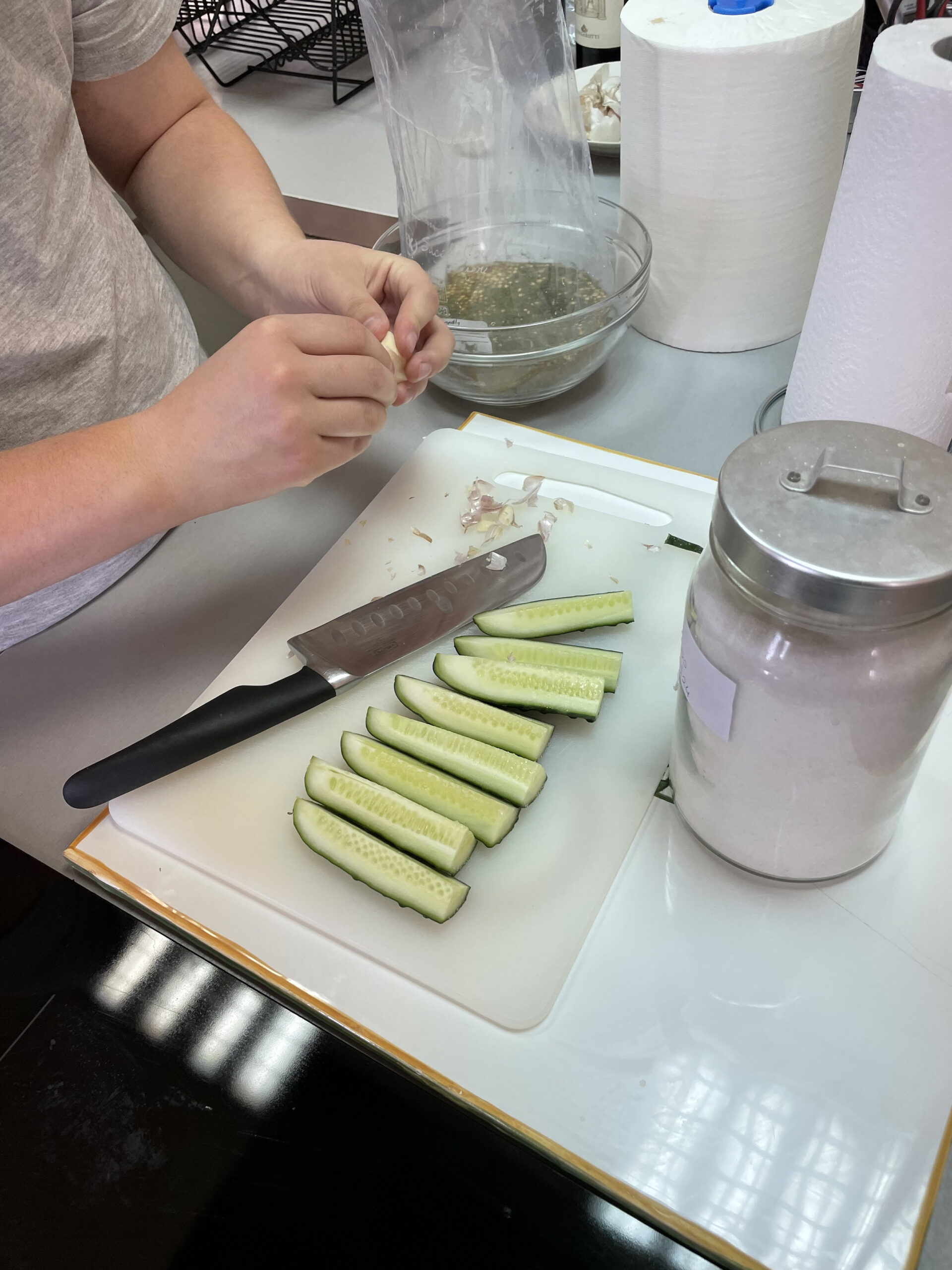 Students cuts up cucumbers for making pickles