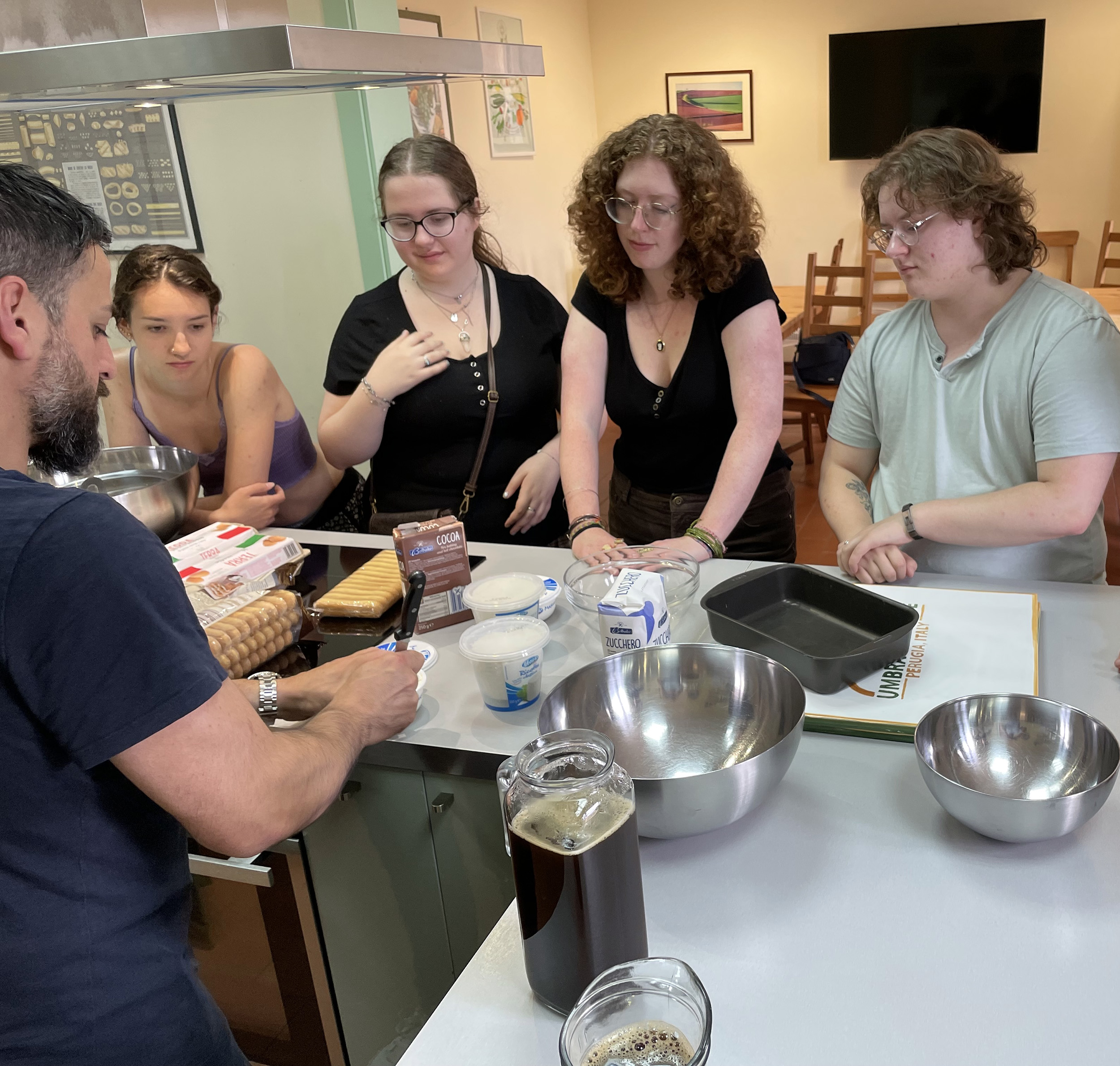 Clark students listening to chef describe how to make tiramasu