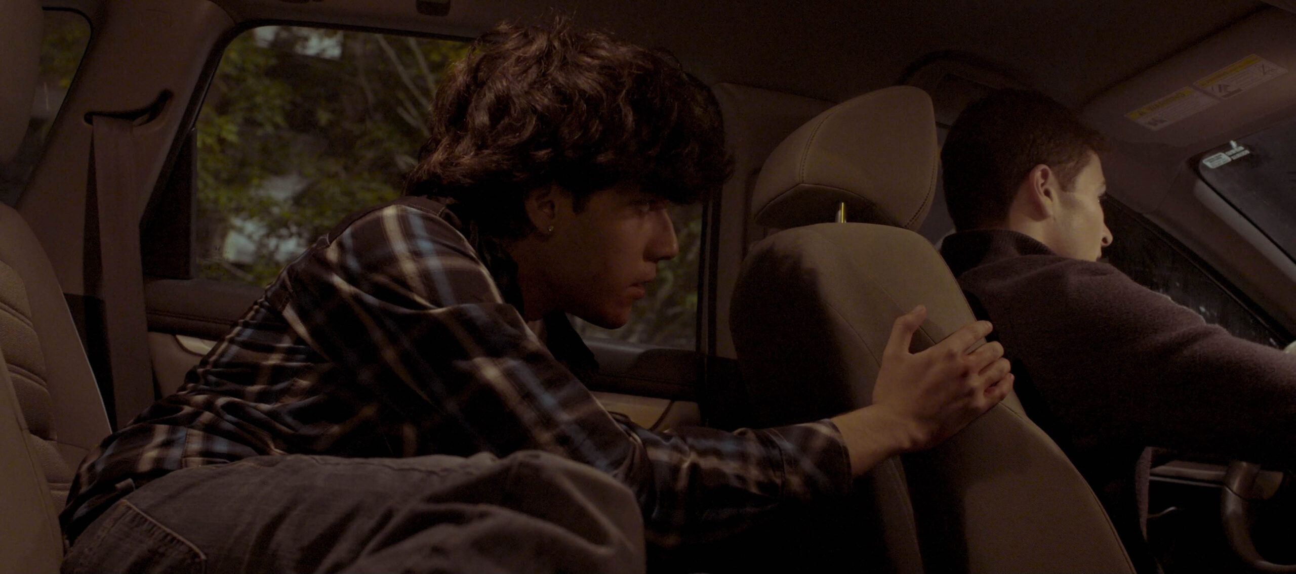 student acting in film inside car