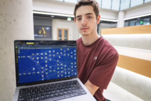 student holding laptop