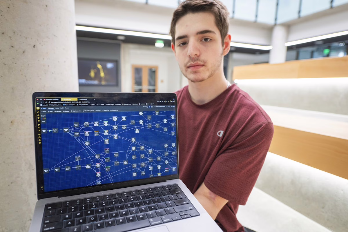 student holding laptop