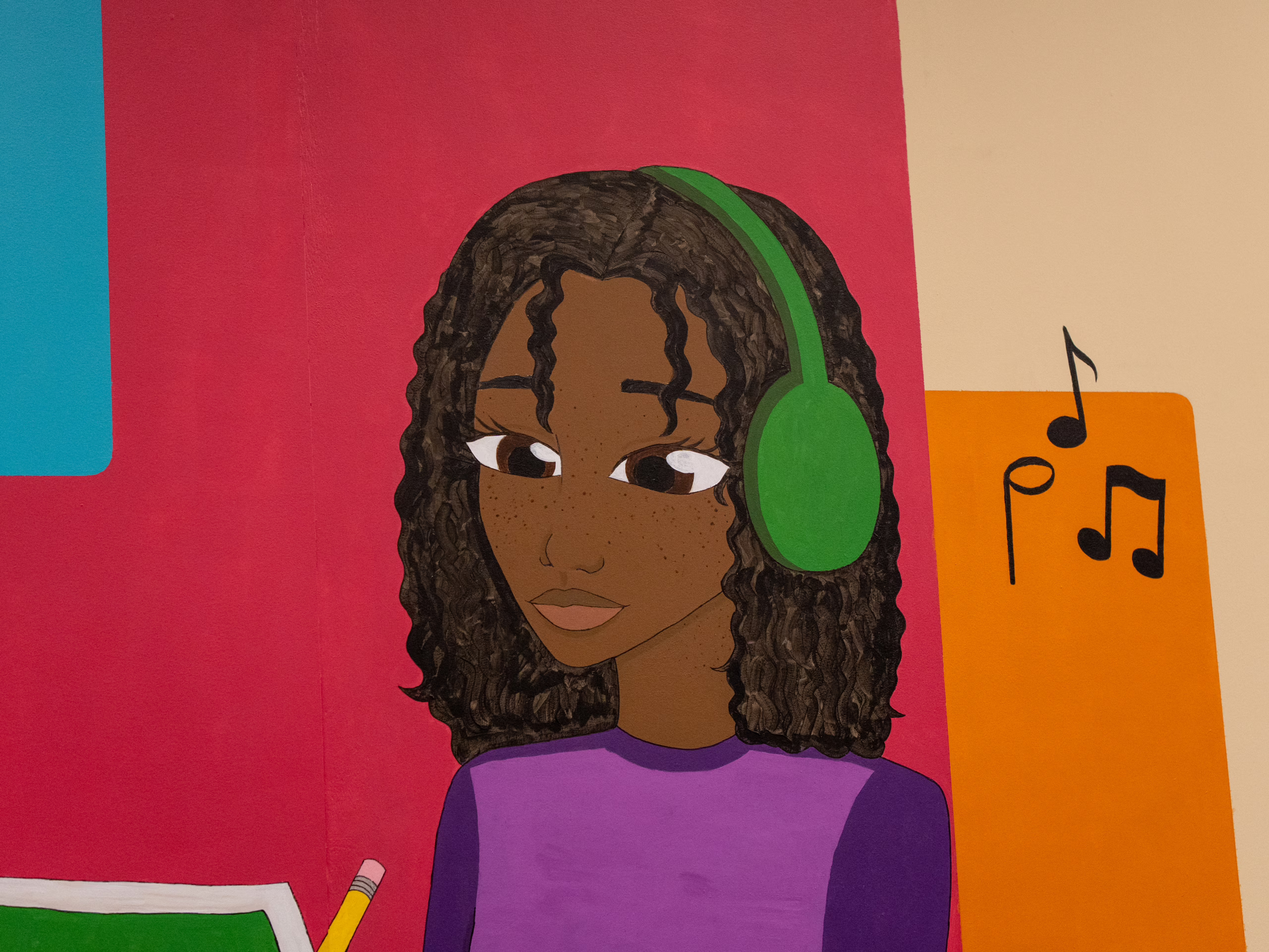 mural in library depicting woman studying