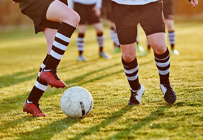 Teens playing soccer