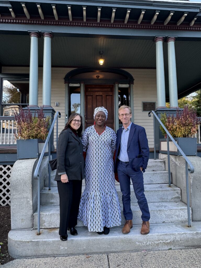 three people pose for photo on steps