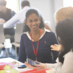 students talk at event