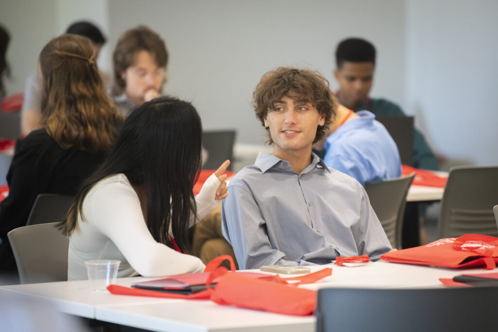 students talk at event