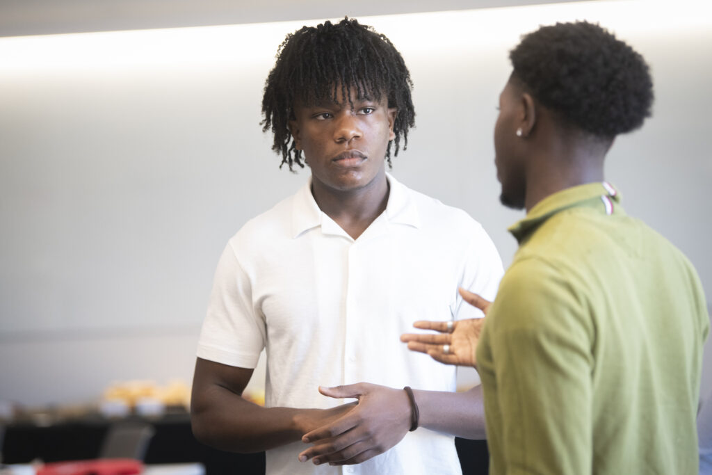 students talk at event