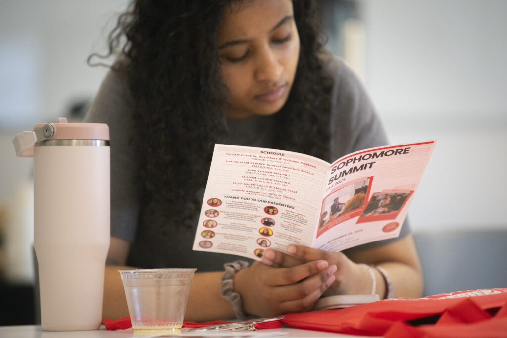 student reads pamphlet