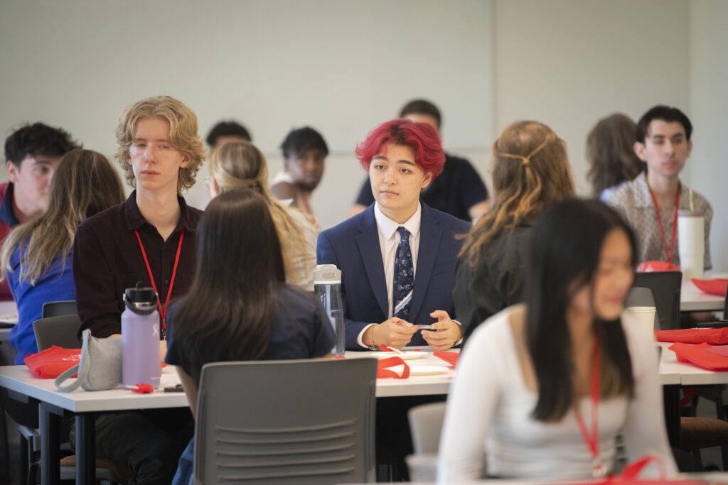 students sitting at table at event