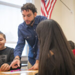 Ariel Rodriguez ’26 works with students at Southbridge High School.