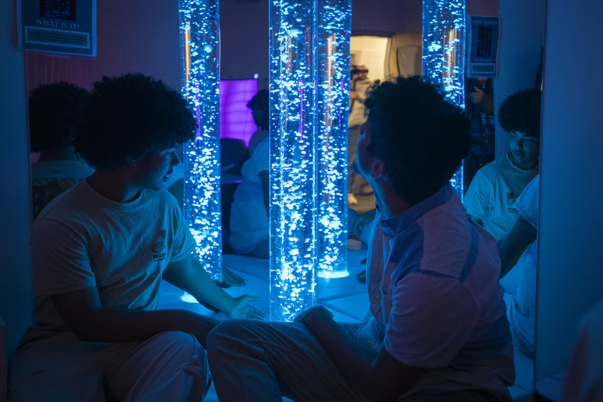 Students examine bubble tube lights in the Southbridge High School sensory immersion room