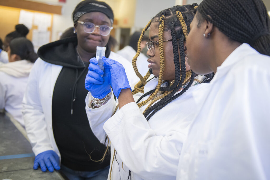 North High School students examine a tube of liquid.