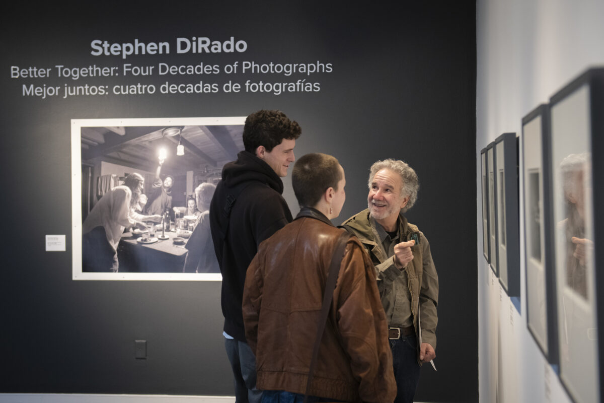 professor and two students at art show