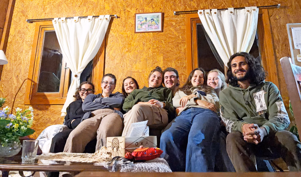 Students sit together on a couch on an overnight stay in Oxapampa.